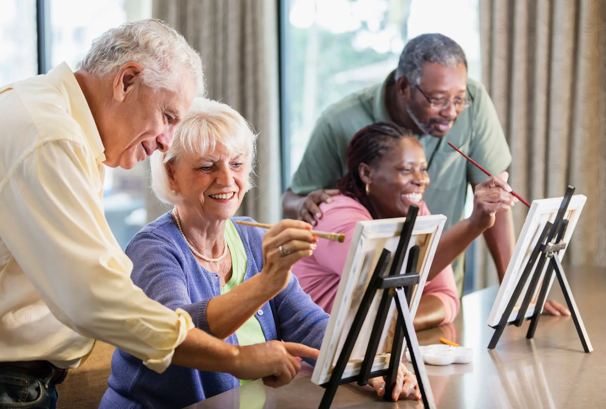 Residents enjoying a group painting activity at Charter Senior Living of Newport News in Virginia